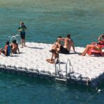A floating swim platform with people hanging out
