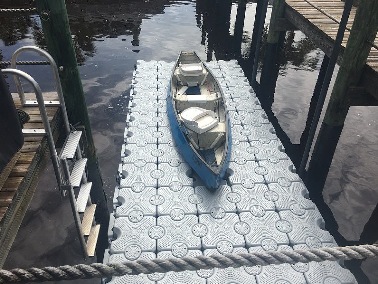 A kayak on top of a floating dock.