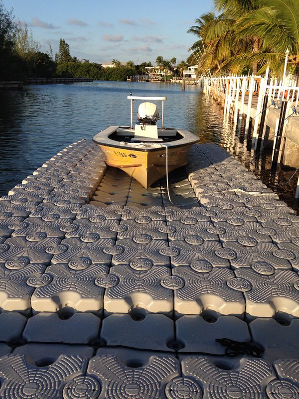 A fishing boat on top of a floating dock.