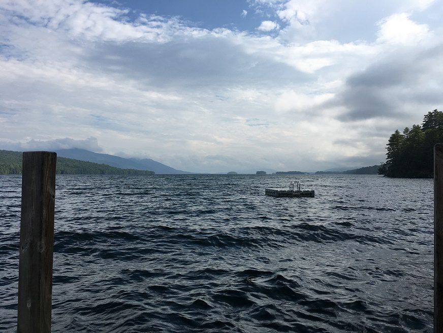 A small floating dock sits in the middle of a lake.