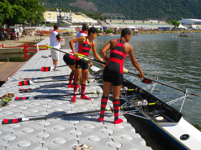 A rowing competition, teams standing on a floating dock