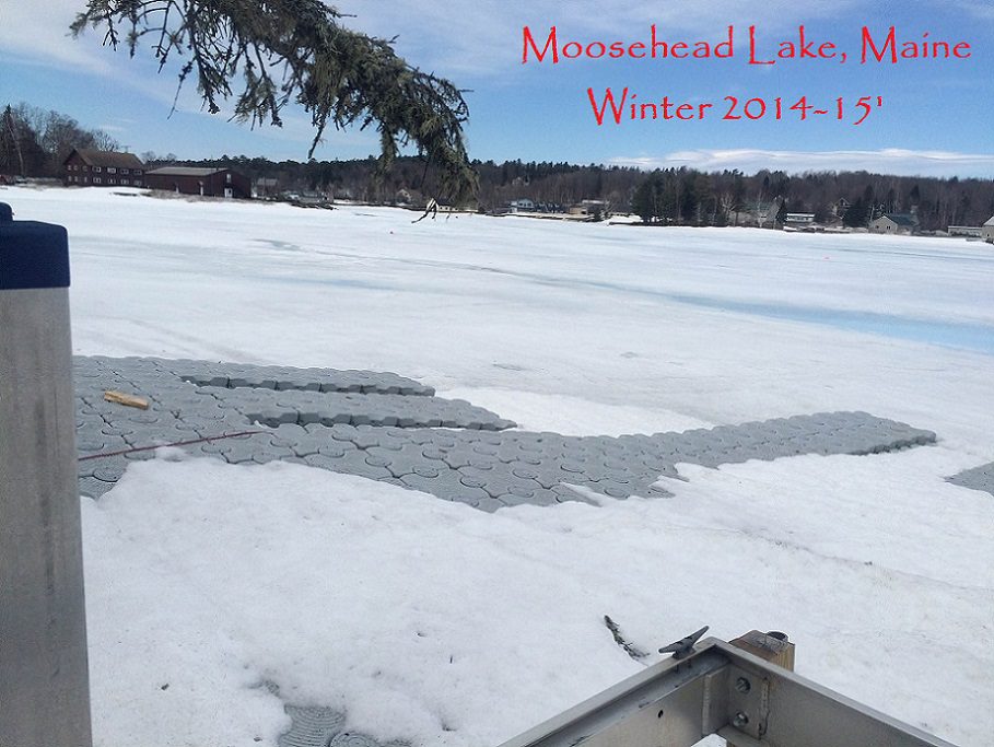 A floating dock is iced over in the winter with the text "Moosehead Lake, Maine. Winter 2014-15" superimposed.