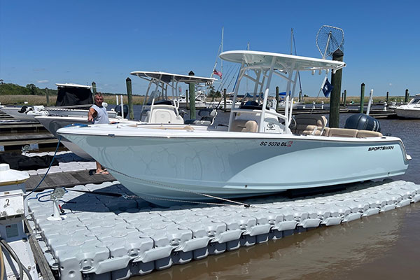 A center console boat docking on a drive on boat lift